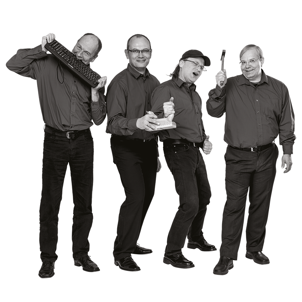 Vier Männer in dunklen Hemden und Hosen stehen nebeneinander, einer hält eine Tastatur, ein anderer einen Schraubendreher, zwei zeigen Daumen hoch.